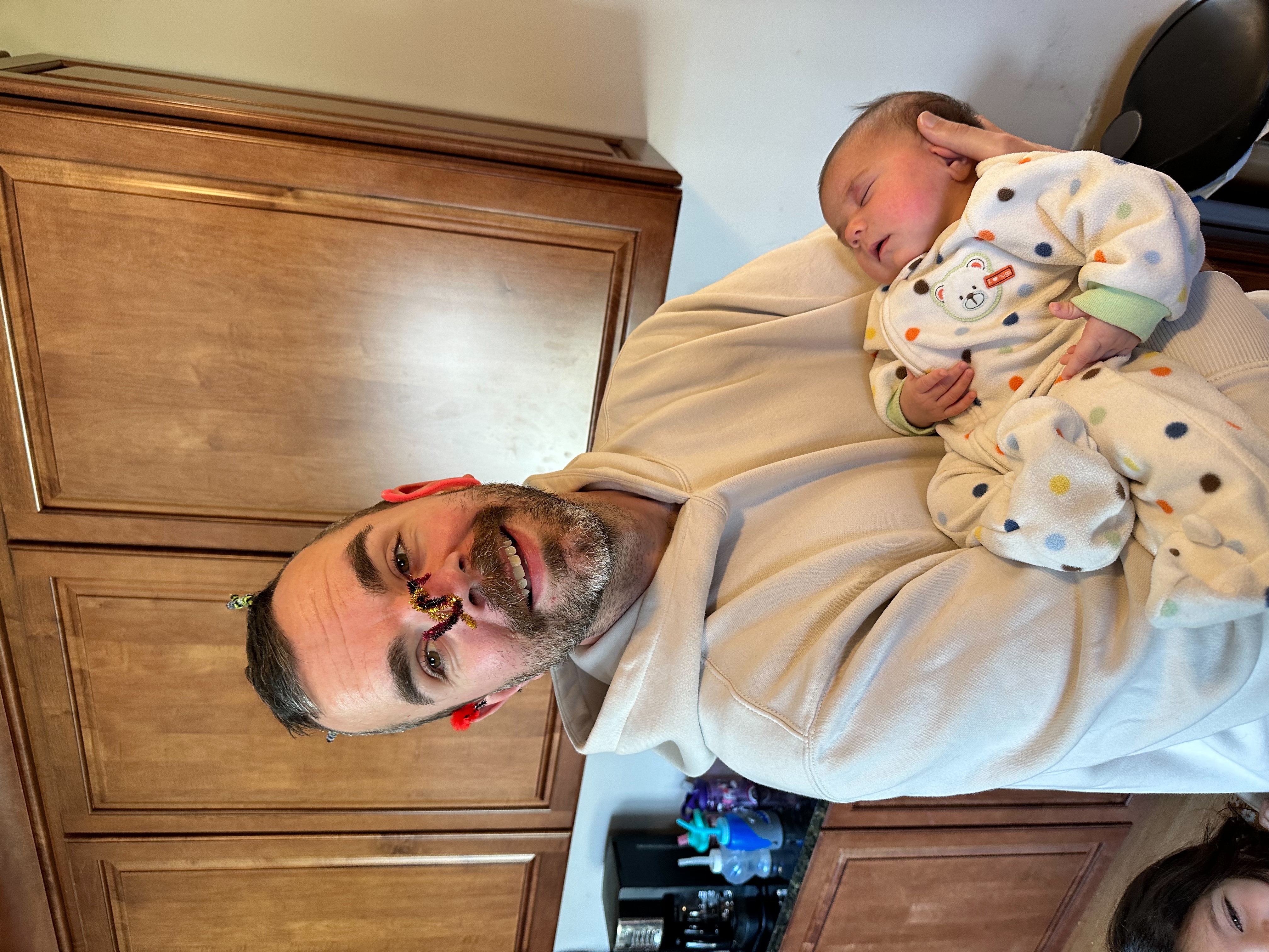 Steve with baby Skylar, clothespin on nose